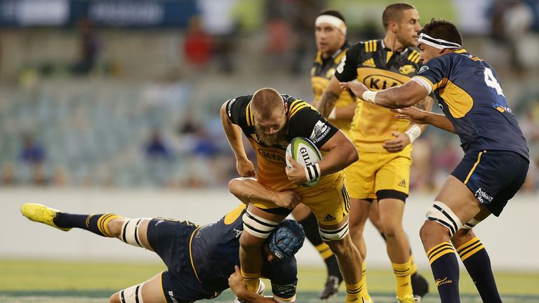 Brad Shields of the Hurricanes is tackled by Scott Fardy of the Brumbies