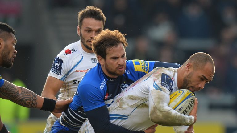 Danny Cipriani of Sale Sharks tackles Olly Woodburn  of  Exeter Chiefs