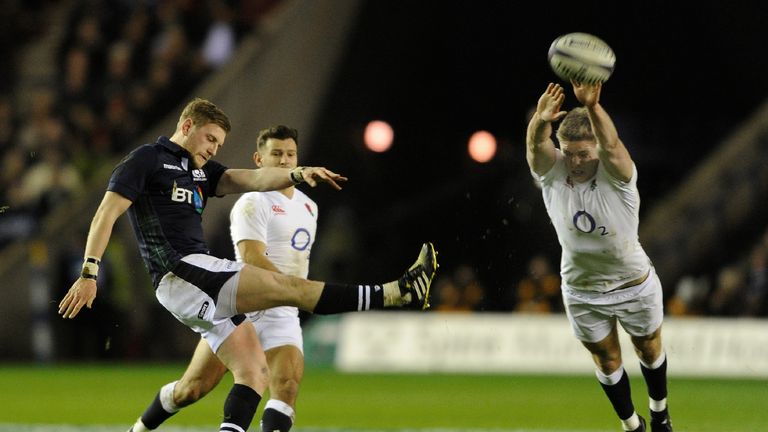 England centre Owen Farrell (R) attempts to block a kick from Scotland fly half Finn Russell during their Six Nations match at Murrayfield