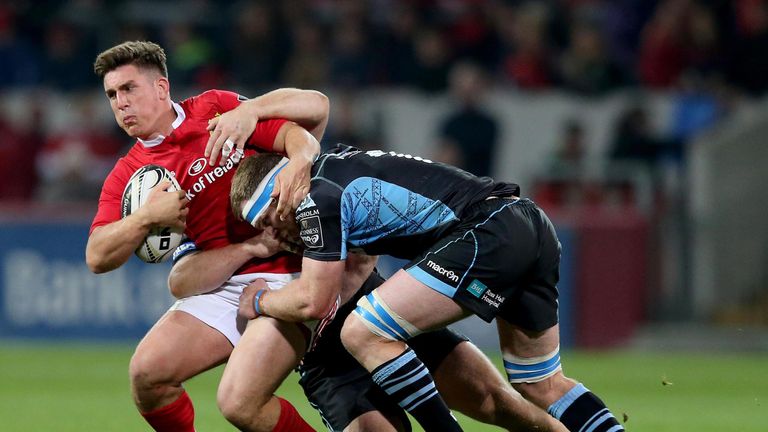Ian Keatley is tackled by Chris Fusaro and Pat MacArthur during Munster's win over Glasgow