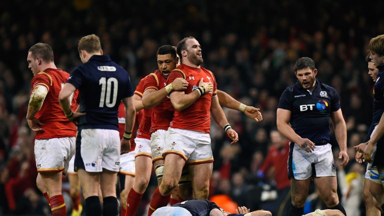 Jamie Roberts of Wales is congratulated by Taulupe Faletau after scoring their second try against Scotland