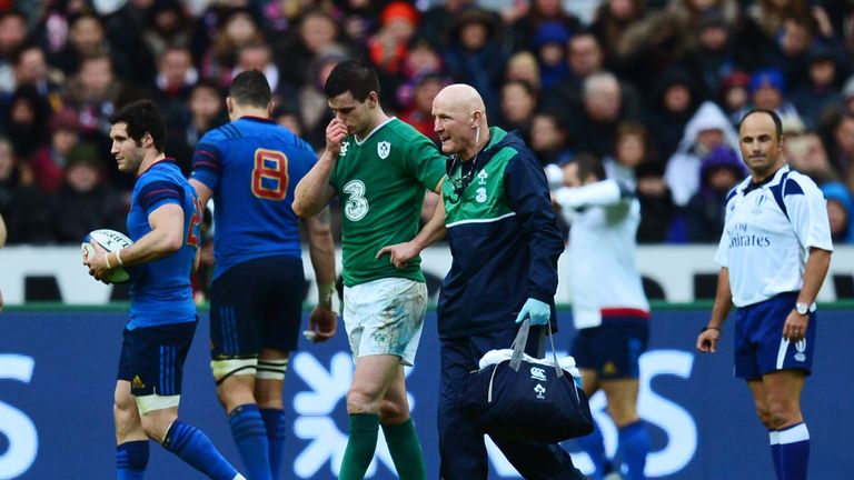 Ireland fly-half Jonathan Sexton leaves the pitch due to injury against France