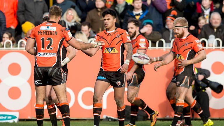Denny Solomona (c) is congratulated after scoring a try against Wakefield