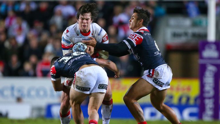 St Helens' Louie McCarthy-Scarsbrook is tackled by Sydney Roosters pair Jayden Nikorima (R) and Ian Henderson