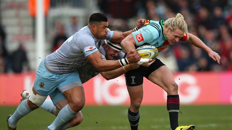 Matt Hopper of Harlequins is tackled by Luther Burrell of Northampton Saints 