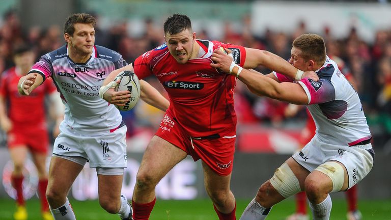 Scarlets and Wales prop Rob Evans is tackled by Ospreys' Lloyd Ashley