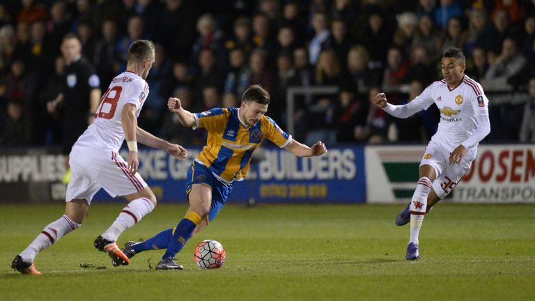 Morgan Schneiderlin (L) and Jesse Lingard (R) vie with Shrewsbury Town's English striker Andy Mangan