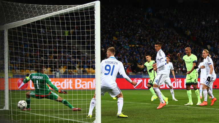 KIEV, UKRAINE - FEBRUARY 24:  Sergio Aguero #10 of Manchester City scores the opening goal past goalkeeper Oleksandr Shovkovskiy of Dynamo Kiev 