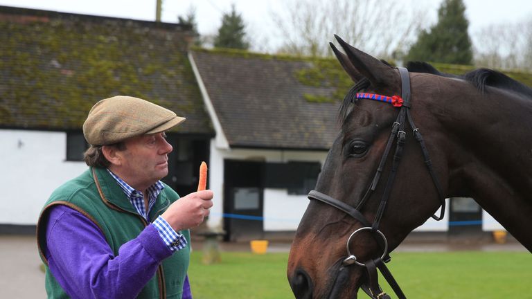 Trainer Nicky Henderson with a carrot for Sprinter Sacre ahead of the Cheltenham Festival in March, during a stable visite to Nicky Henderson's stables at 