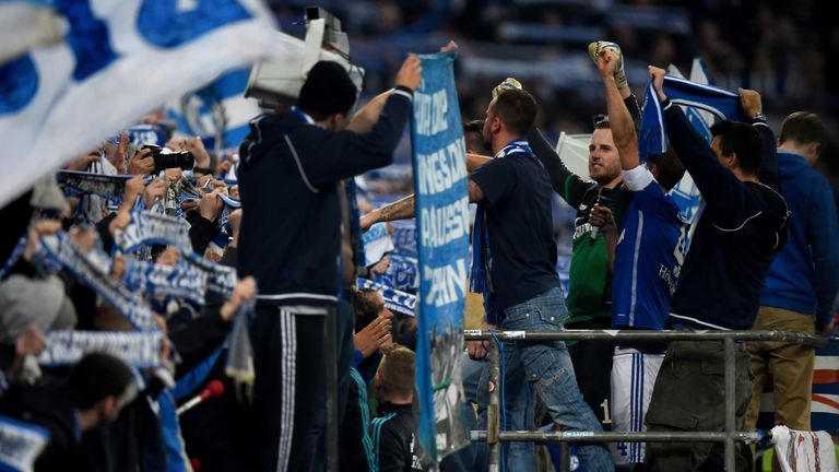 Bendeikt Hoewedes of Schalke and goalkeeper Ralf Faehrmann of Schalke celebrate with their team mates and fans 