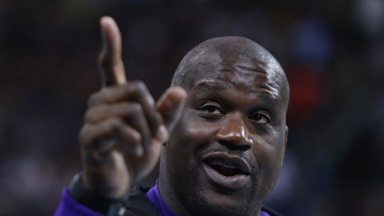 NBA legend Shaquille O'Neal gestures as he watches the Brooklyn Nets versus the Sacramento Kings during the 2014 NBA Global Games