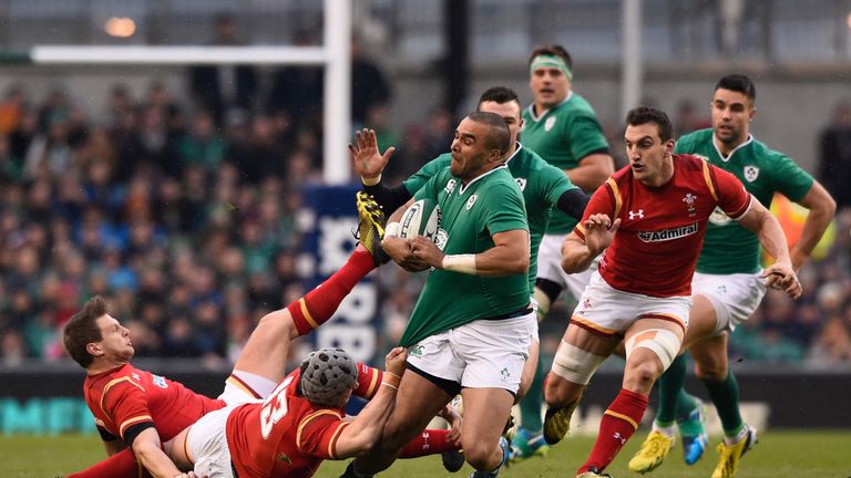 Simon Zebo of Ireland is hauled down by Jonathan Davies of Wales during the RBS Six Nations