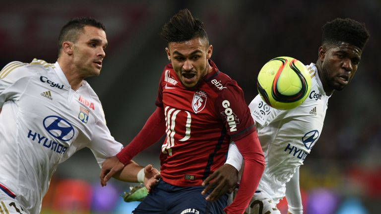 Lille midfielder Sofiane Boufal (centre) vies with Lyon defender Samuel Umtiti (right) and Jeremy Morel.