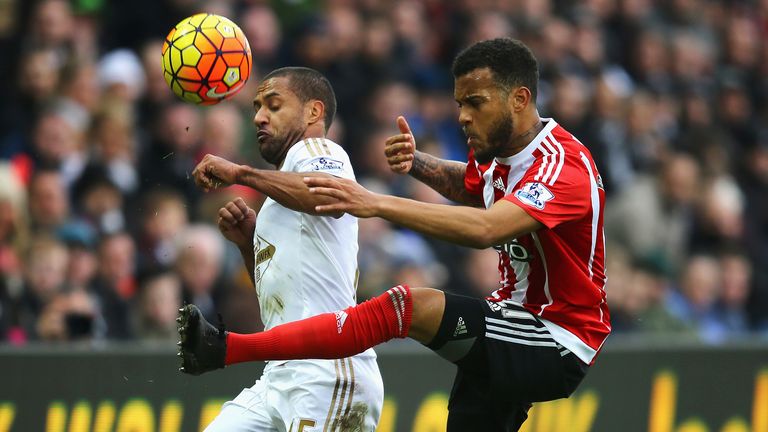 SWANSEA, WALES - FEBRUARY 13:  Ryan Bertrand of Southampton and Wayne Routledge of Swansea City compete for the ball during the Barclays Premier League mat