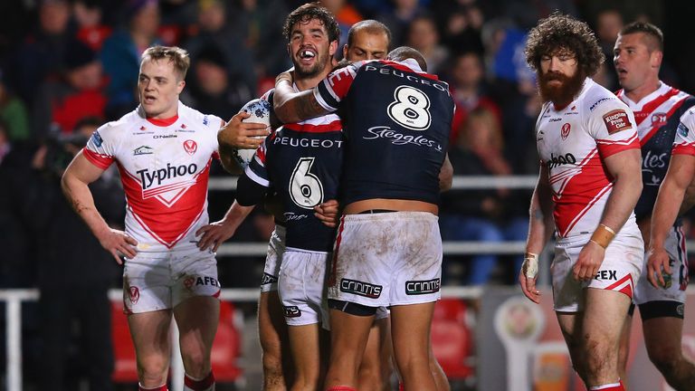 Aidan Guerra of Sydney Roosters celebrates with team-mates after scoring the second try during the World Club Series match v St Helens