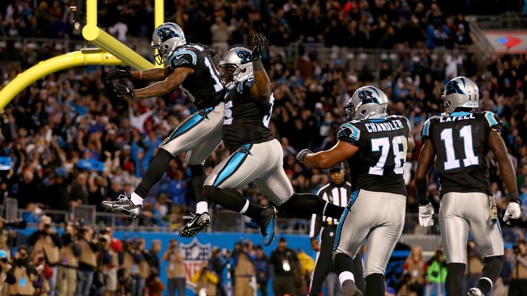 Ted Ginn #19 celebrates scoring the game winning touchdown with teammate Mike Tolbert #35 of the Carolina Panthers during th