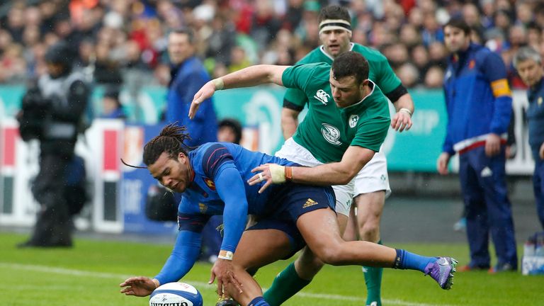 France's wing Teddy Thomas fights for the ball with Ireland's fullback Robbie Henshaw