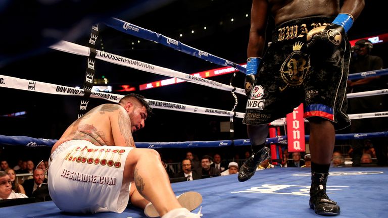 Chris Arreola sits on the canvas after being knocked down for the first time in the sixth round by Bermane Stiverne