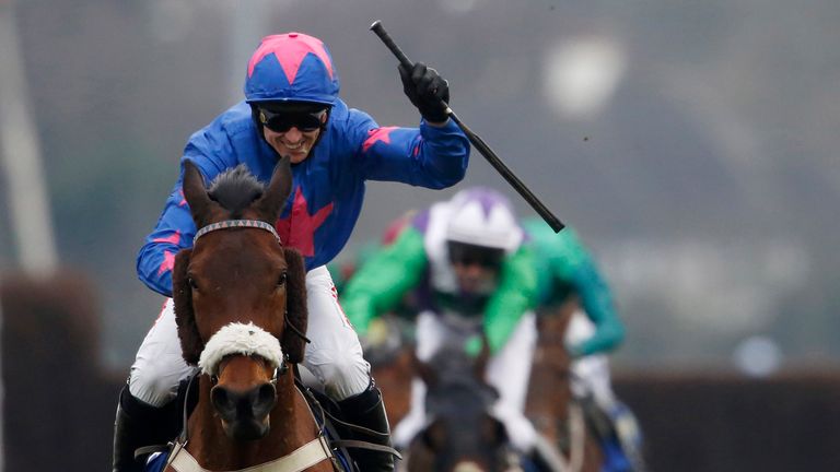 SUNBURY, ENGLAND - FEBRUARY 27:  Paddy Brennan celebrates riding Theatre Guide as they win The BetBright Steeple Chase at Kempton Park racecourse on Februa