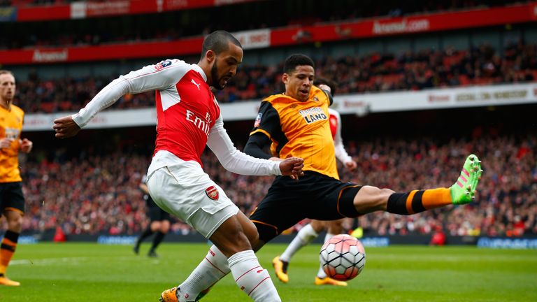 Theo Walcott of Arsenal and Curtis Davies of Hull City compete for the ball during the Emirates FA Cup fifth round match 