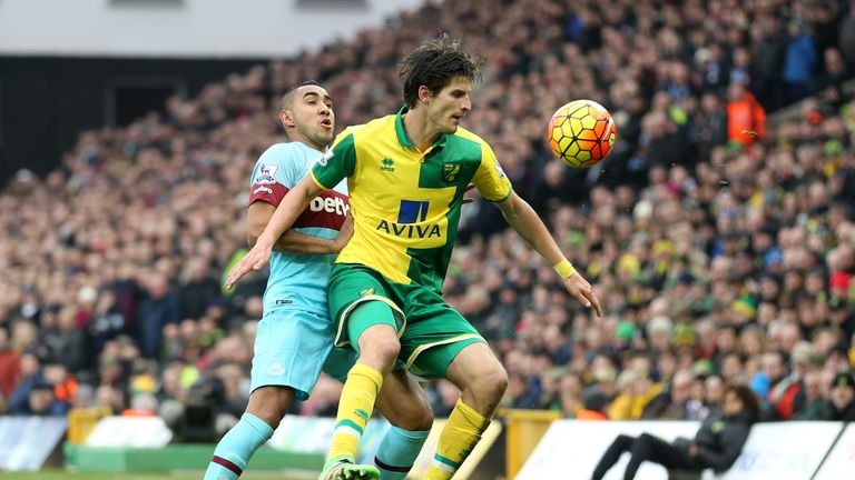 Norwich City's Timm Klose (right) tussles with West Ham United's Dimitri Payet