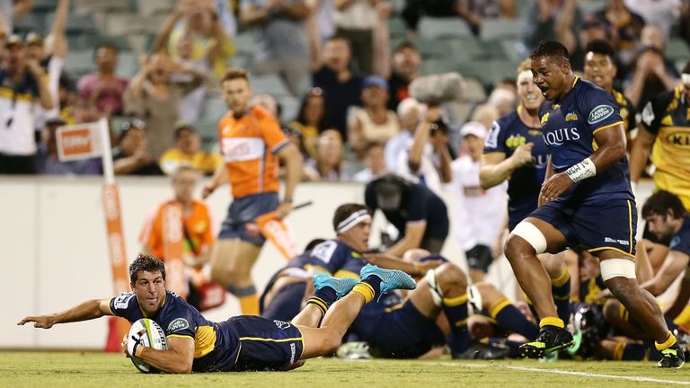 Tomas Cubelli of the Brumbies scores a try against the Hurricanes