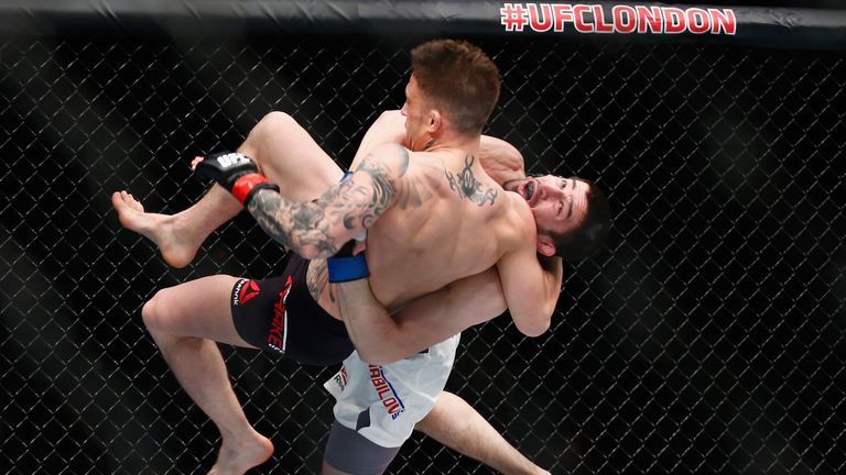 Rustam Khabilov of Russia (Black Shoirts) throws Norman Parke of Nortern Ireland during the Middleweight Bout of the UFC Fi