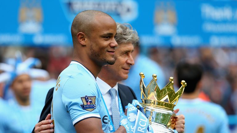 Vincent Kompany and Manuel Pellegrini celebrate with the Premier League trophy in 2014