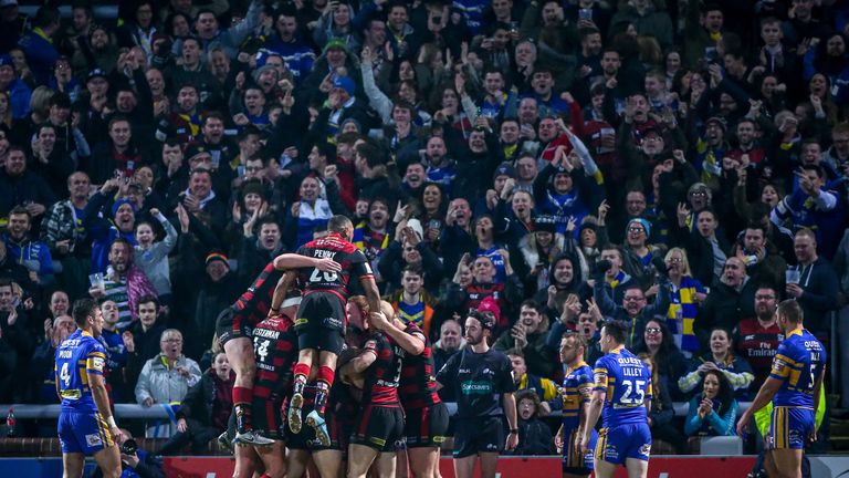 Warrington celebrate a try by Chris Sandow