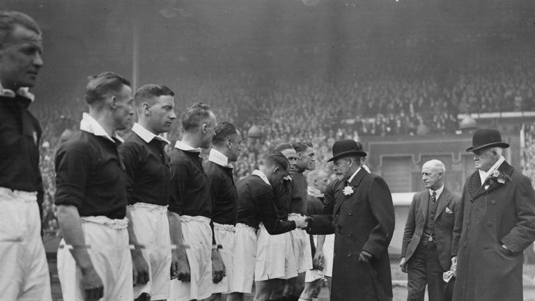 April 1934:  King George V (1865 - 1936) shakes hands with members of Wilf Wild's Manchester City football  team before the 1934 FA Cup Final at Wembley