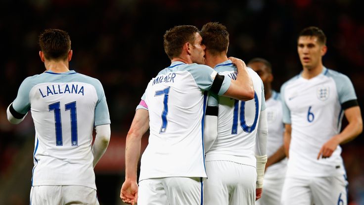 Jamie Vardy of England is congratulated by James Milner after scoring the opening goal during the International Friendly match 