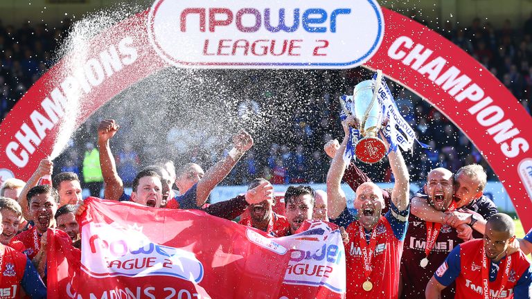 GILLINGHAM, ENGLAND - APRIL 20:   Adam Barrett, Captain of Gillingham lifts the trophy after securing promotion during the npower League Two match between 