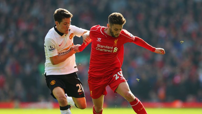 Adam Lallana of Liverpool is challenged by Ander Herrera of Manchester United