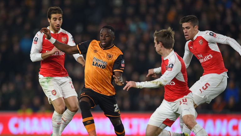 Hull City's Adama Diomande vies with Arsenal's Mathieu Flamini (L), Nacho Monreal (2nd R) and Gabriel (R) during the FA cup fifth round replay.