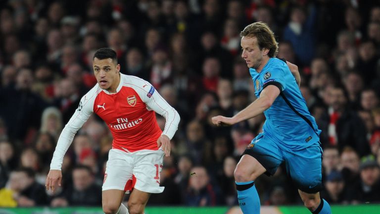 Alexis Sanchez of Arsenal breaks past Ivan Rakitic of Barcelona