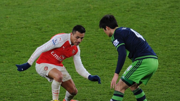 Alexis Sanchez of Arsenal takes on Sung-Yueng Ki of Swansea during the Premier League match at Emirates Stadium on March 2, 2016 in London, England. 