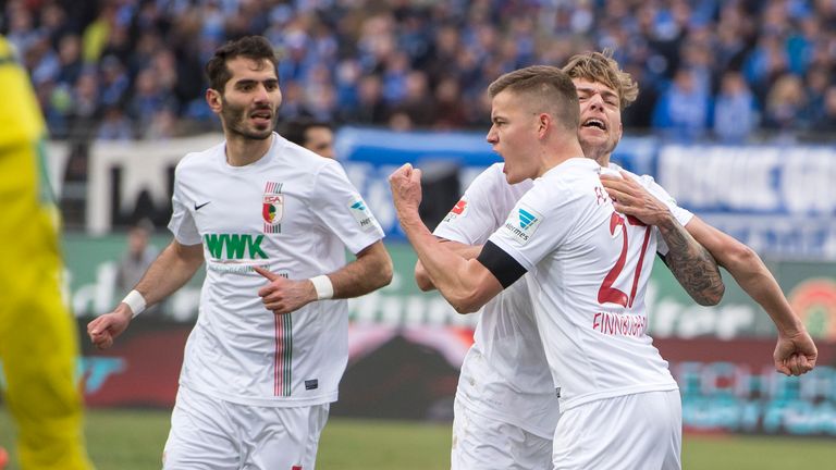 Alfred Finnbogason of FC Augsburg celebrates the second goal with Alexander Esswein (m) and Halil Altintop (l) 