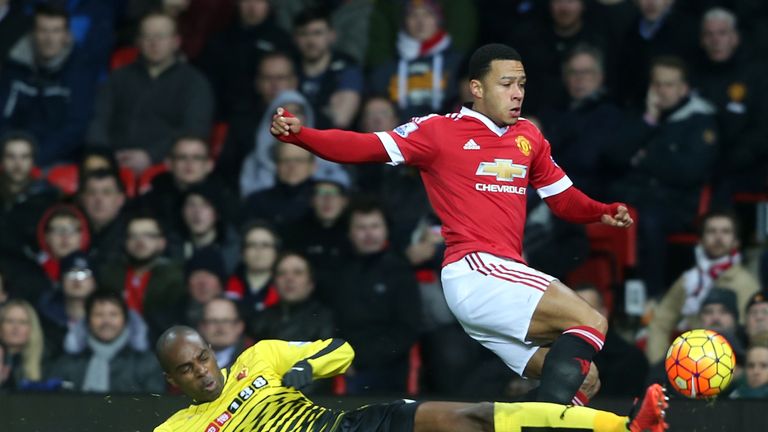 Memphis Depay of Manchester United attempts to avoid a challenge from Watford's Allan Nyom 