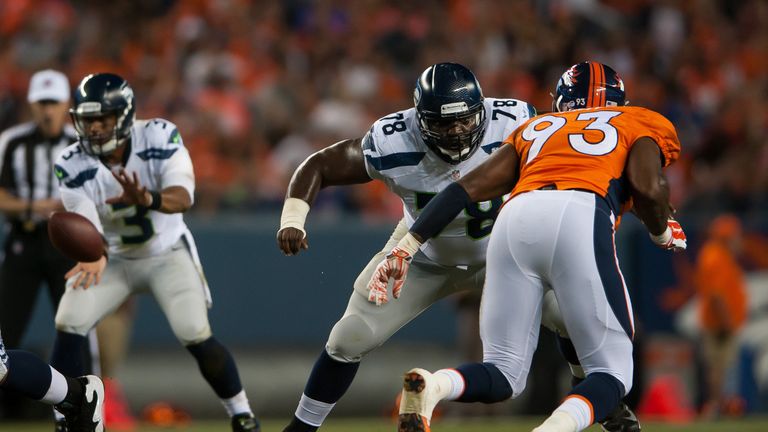 Tackle Alvin Bailey #78 of the Seattle Seahawks blocks against defensive end Quanterus Smith #93 of the Denver Broncos during pres