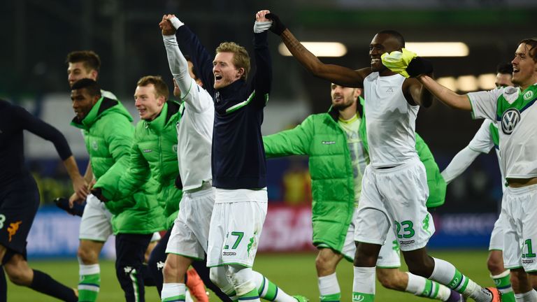 Andre Schuerrle and teammates react after 1-0 victory during the second-leg round of 16 UEFA Champions league football match between Wolfsburg and KAA Gent