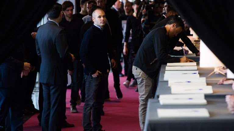BARCELONA, SPAIN - MARCH 29: Andres Iniesta (C) looks on as Head coach Luis Enrique Martinez (R) of FC Barcelona writes a condolence message before paying 