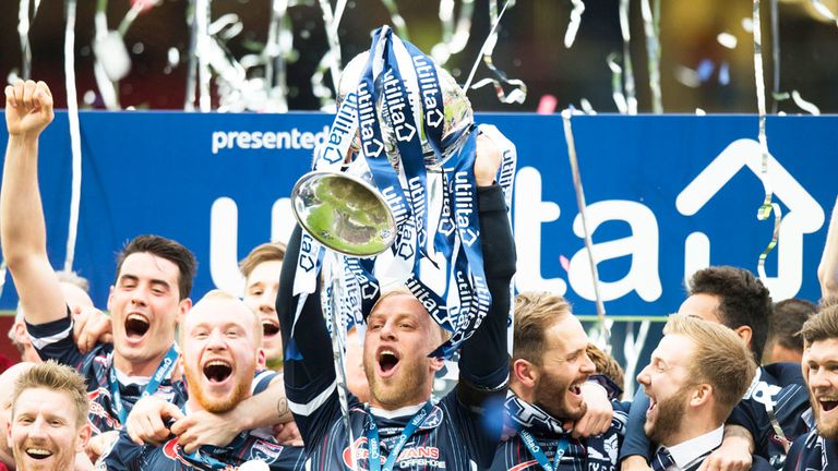 Ross County skipper Andrew Davies holds the Scottish League Cup aloft