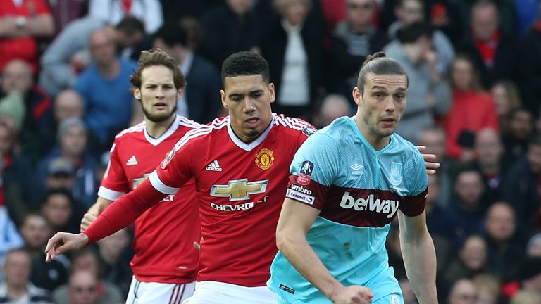 Chris Smalling of Manchester United in action with Andy Carroll of West Ham United