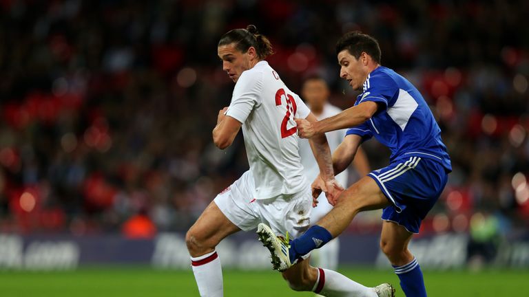 Andy Carroll of England competes for the ball with Alex Gasperoni of San Marino during the FIFA 2014 World Cup Group H qualifier