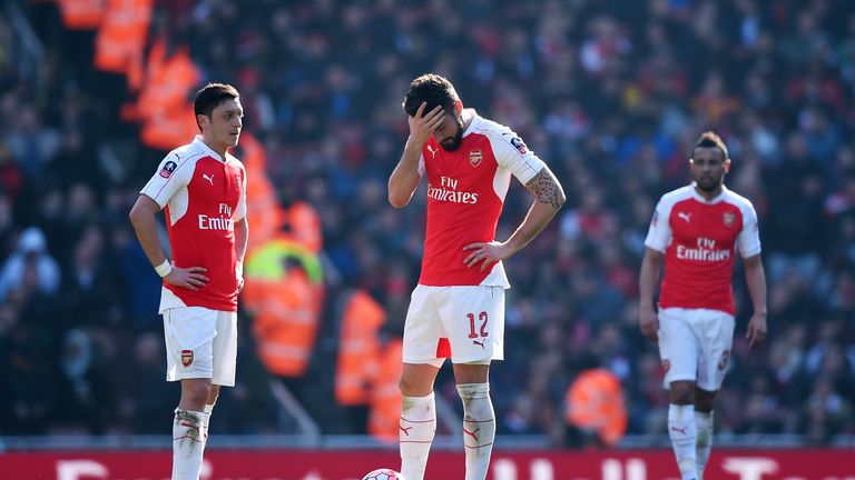 Arsenal players stand dejected after Watford's first goal