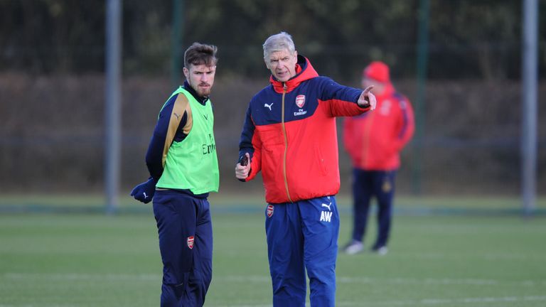 Arsenal manager Arsene Wenger gives instructions to Aaron Ramsey during a training session at Arsenal's London Colney training ground on March 4, 2016.