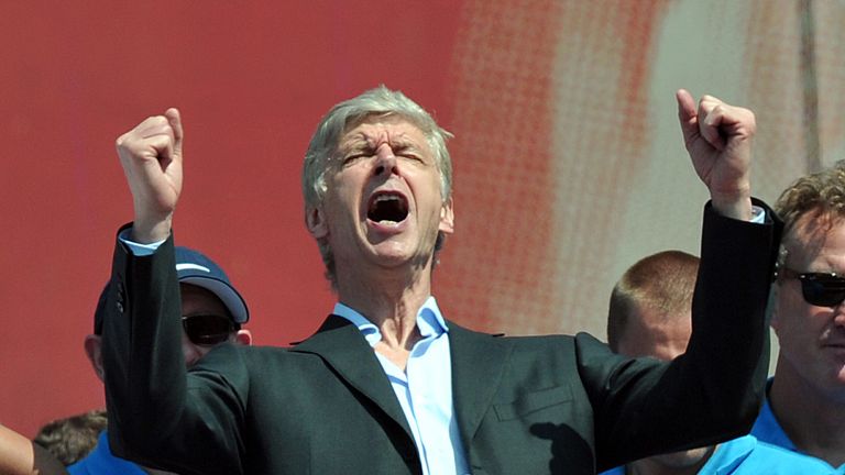 Arsenal manager Arsene Wenger celebrates outside the Emirates Stadium during the FA Cup winners parade in London, May 2014