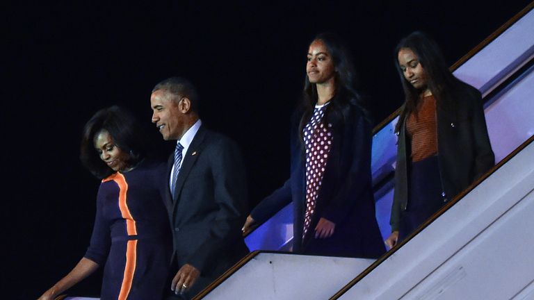 US President Barack Obama, First Lady Michelle Obama and their daughters Malia and Sasha walk off arrive in Buenos Aires on March 23, 2016.