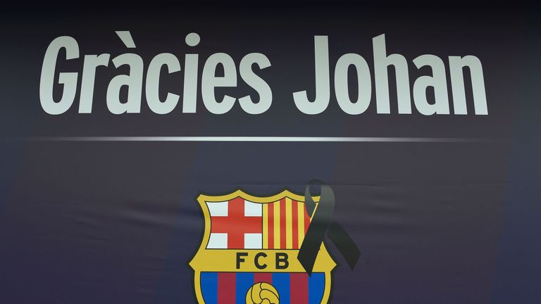 A Barcelona football team logo marked with a black sash is pictured at Camp Nou stadium