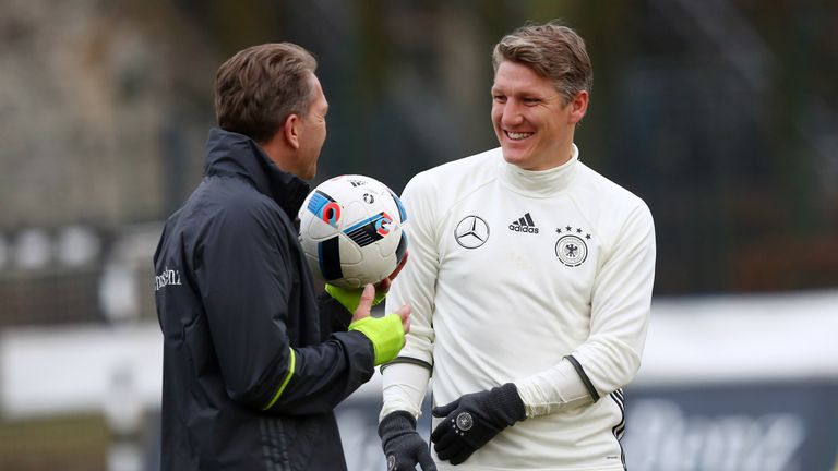 Goalkeeper coach Andreas Koepke (L) of Germany and Bastian Schweinsteiger (R) look on during a Germany training session